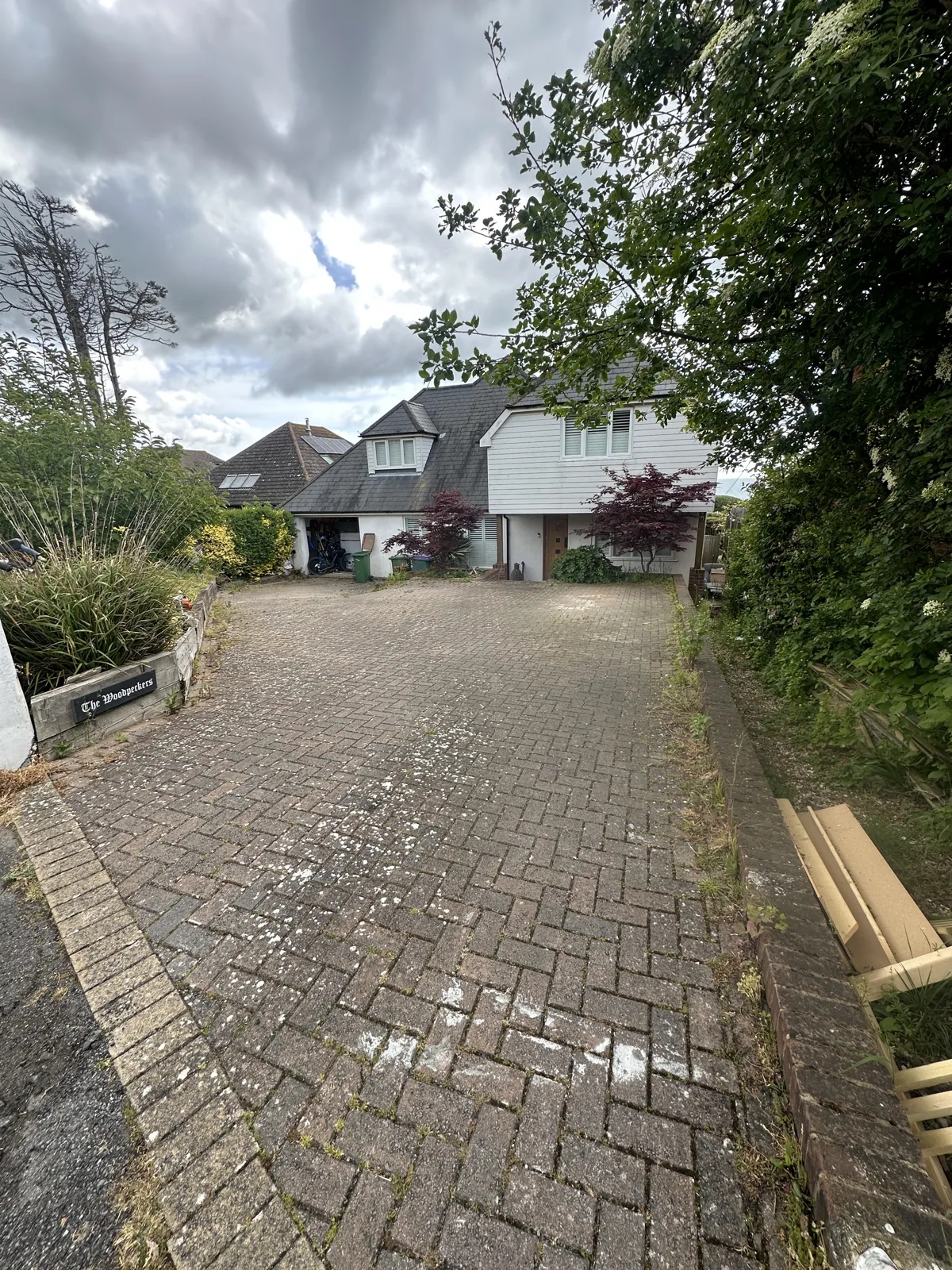 Block paving driveway before cleaning in Kent, weeds and heavy staining
