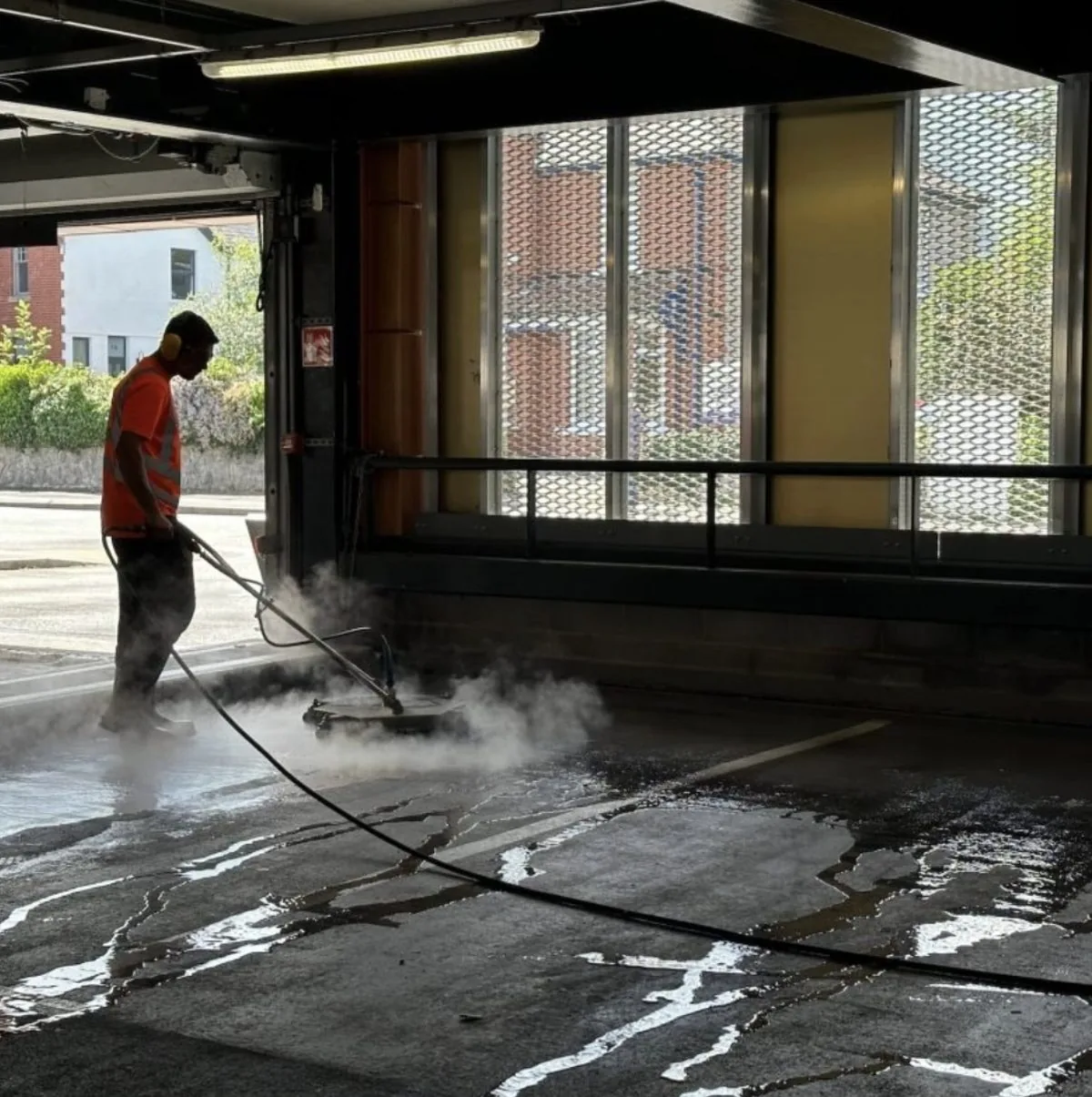 Steam and pressure cleaning a commercial multi-storey car park floor
