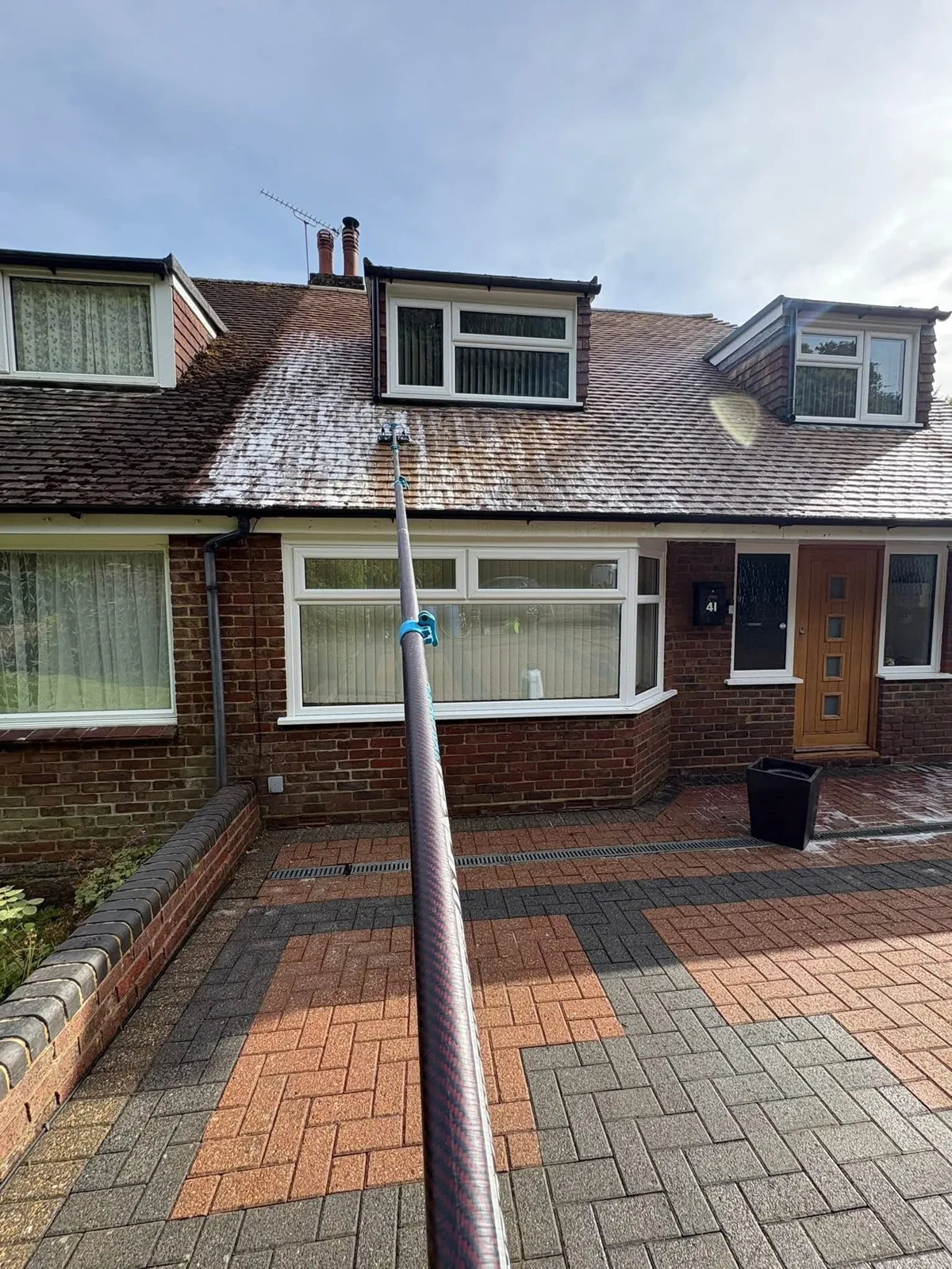 Roof being cleaned with a water-fed pole from ground level in Folkestone, Kent